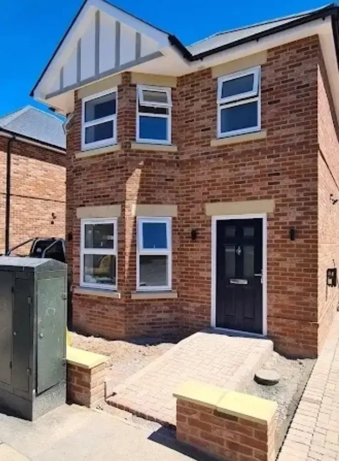 Finished new front door installation at a brick home.