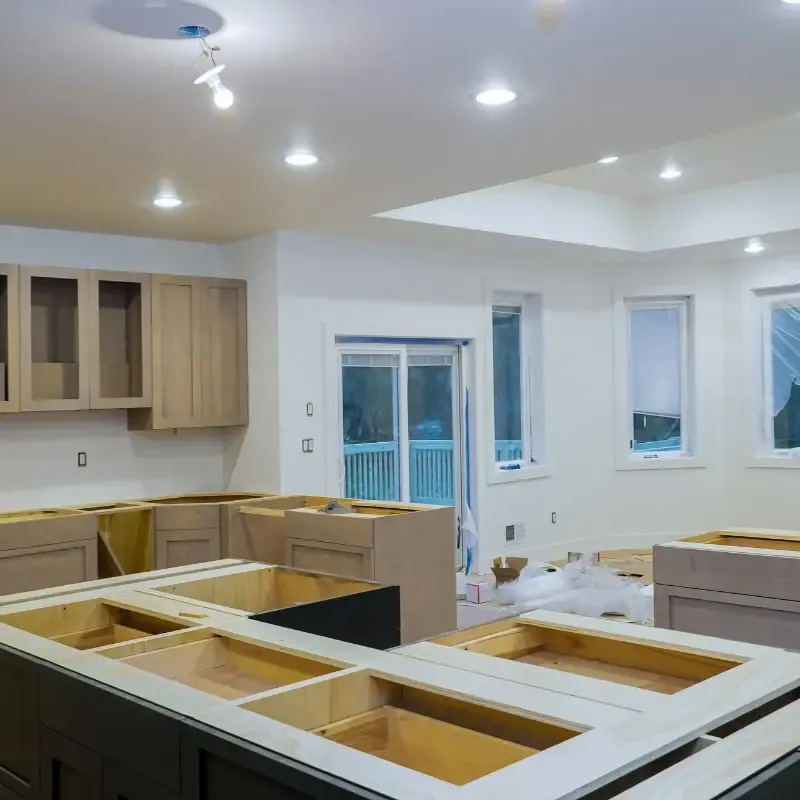 Finished kitchen renovation with modern lighting and cabinetry.