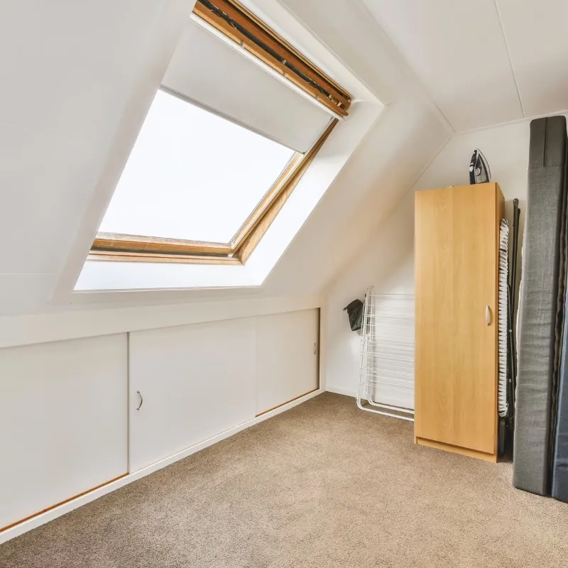 Finished loft room with skylight and fitted storage.