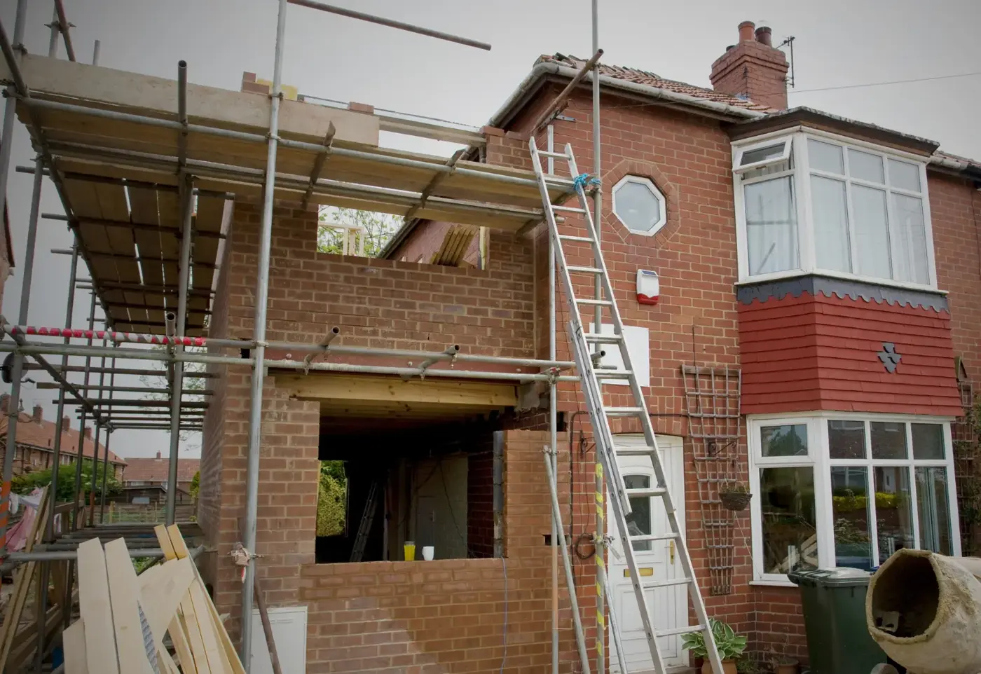 Single-storey brick extension with scaffolding
